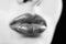 Female lips close up. Lipstick on the lips. Luxury symbol. Part of a female face on a black background. Elegant lady.