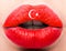 Female lips close up with a picture flag of Turkey. Red and white month, star