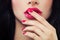 Female Lips and Nails Closeup. Pink Nail Polish