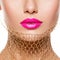 Female lips with pink lipstick and golden veil on the neck. closeup