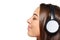 Female listening enjoying music in headphones with closed eyes