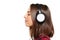 Female listening enjoying music in headphones with closed eyes