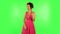 Female listens attentively and nods his head pointing finger at viewer and shows ok sign. Green screen
