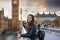 Female London traveler enjoys the view to the Westminster Palace and Big Ben clocktower
