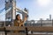 Female London traveler takes a selfie picture in front of the Tower Bridge