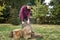 Female lumberjack with chainsaw cutting wood