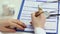 Female M.D. filling out patient registration form, keeping clinical records