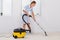 Female Maid Cleaning With Vacuum Cleaner