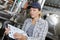 Female maintenance worker testing brewery machine at brewery