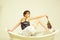 Female make-up. Fashionable woman posing. young woman resting in spa bathtub with fashionable hair, lilac