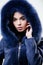 Female with makeup wear dark blue soft fur coat. Woman wear hood with fur. Fashion concept. Girl elegant lady wear