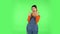 Female making a rock gesture, enjoying life and laughing. Green screen