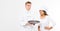 Female and male chefs hold an empty tray and inhale the pleasant smell of food isolated Copy space