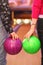 Female and male hands holding balls in bowling c