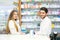 Female and male pharmacists in pharmacy