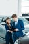 Female and male Sales managers of a car showroom standing and looking