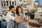 female and male shop assistants in apron using a tablet together