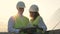 Female and male solar inspectors working near solar panels.