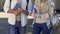 Female and male students holding books, having conversation, college friends