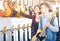 Female and male teenagers examining electric guitars