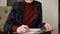 Female manager hands in chair, making notes in paper holding a pencil