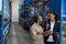 Female manager and male worker discussing over clipboard in warehouse