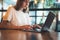 Female manager using laptop at coworking workplace, hipster girl freelancer writing on keyboard, at office, businesswoman working