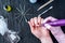 Female manicurist doing a professional manicure hardware using milling cutter on the background of tools