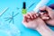 Female manicurist doing a professional manicure hardware using milling cutter on the background of the tools