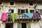 Female mannequins looking out onto the rustic house balcony at the crib of Corgnolo, Porpetto, Udine, Friuli, Italy.