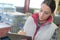 Female manufacturing labourer holding clipboard and noting