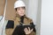 Female manufacturing labourer holding clipboard and noting