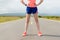 Female marathon runner standing on country road