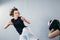 Female martial arts fighter practicing with trainer, punching taekwondo kick pad exercise kicking. Training of kickboxer woman