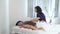 Female masseur massages back relaxed pretty woman