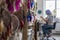 Female master creating Dreamcatcher working at workshop with feathers and materials