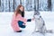 Female master on dog training with siberian husky