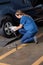 Female Mechanic Adjusting Car Tire
