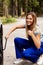 Female mechanic changing tire with wheel wrench