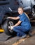 Female Mechanic Fixing Car Tire