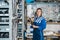 Female Mechanic Holding Timing Belt In Warehouse Of Garage