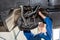 Female Mechanic Repairing Car In Automobile Shop