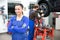 Female mechanic standing in a garage