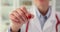 Female medic holds tiny artificial heart model in hand