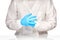 Female medical doctor pulling on blue gloves