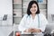 Female Medical Doctor is Working on Table Desktop for Physical Patient Examining in Examination Room, Portrait of Female Physician