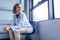 Female medical professional on chair in hospital ward