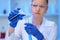 A female medical scientist works in a laboratory. Spcialist conducts experiments, develops auccin auctin from the virus