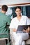 Female Medical Technician Holding Clipboard