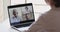 Female medical worker participating online webcam conference call on laptop